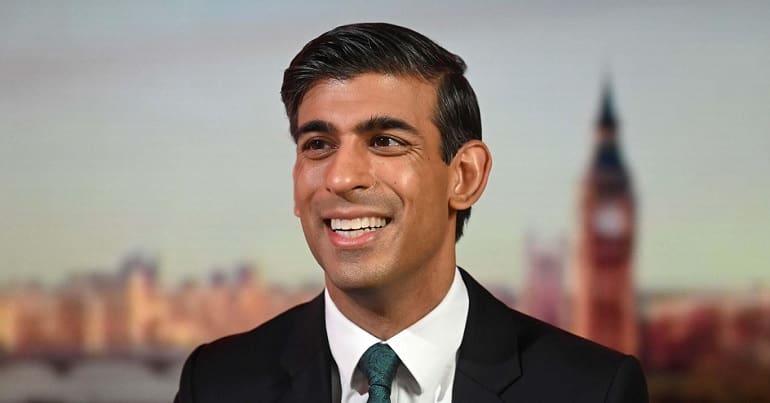 A grinning Rishi Sunak