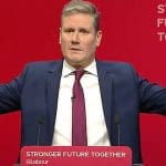 An image of Keir Starmer with his arms spread