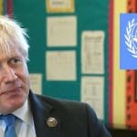 Boris Johnson looking at the blue UN logo