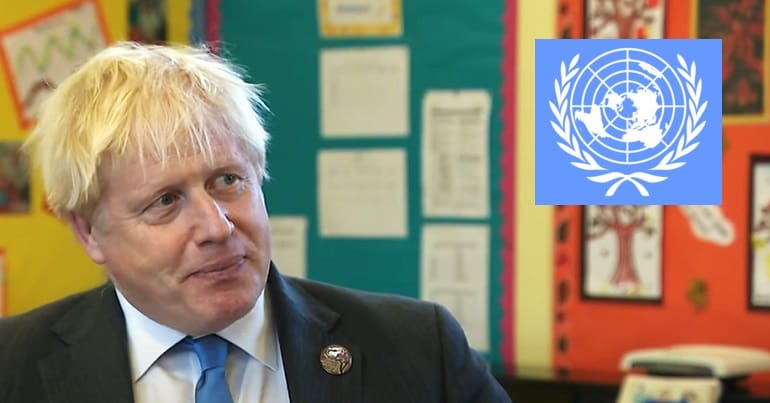 Boris Johnson looking at the blue UN logo