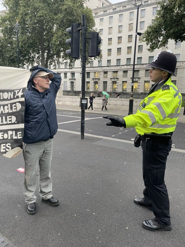 A photo of police trying to move a disability rights protester