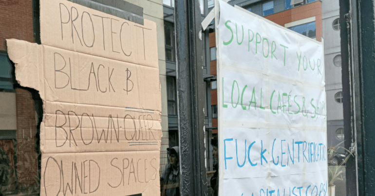 Protest signs up in the window of the Hidden Corner cafe