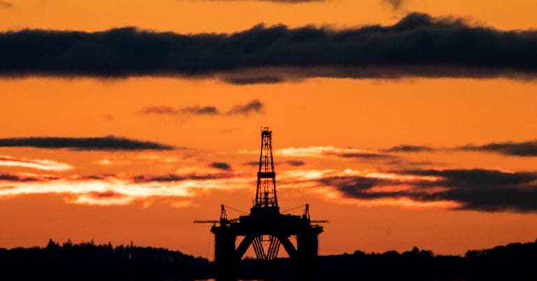 An oil rig at sunset