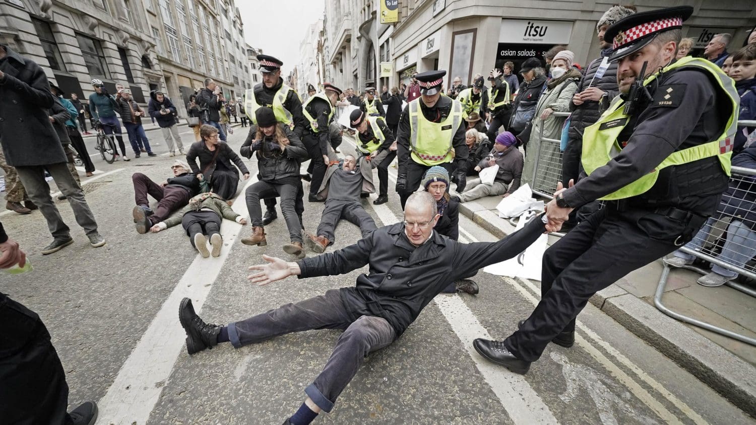 XR protesters being dragged away by the police