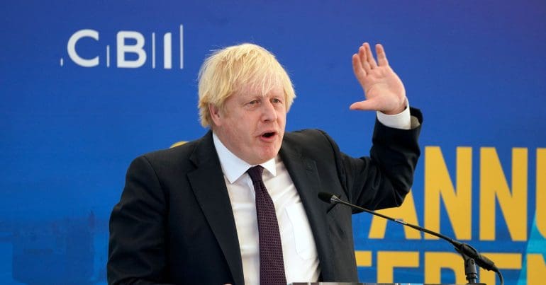 Boris Johnson holding his hand up