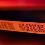 A line of police tape at a shooting in Minneapolis, Minnesota, at night.