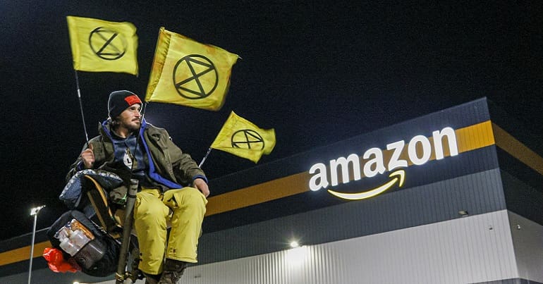 An XR activist outside Amazon on Black Friday