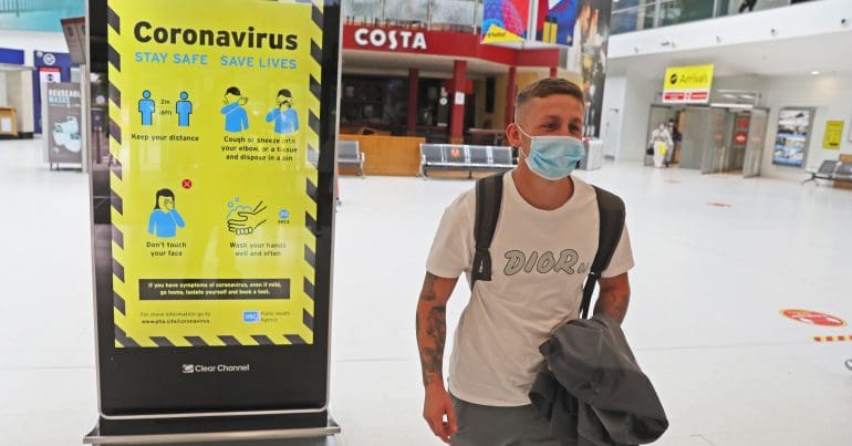 A traveller wearing a mask