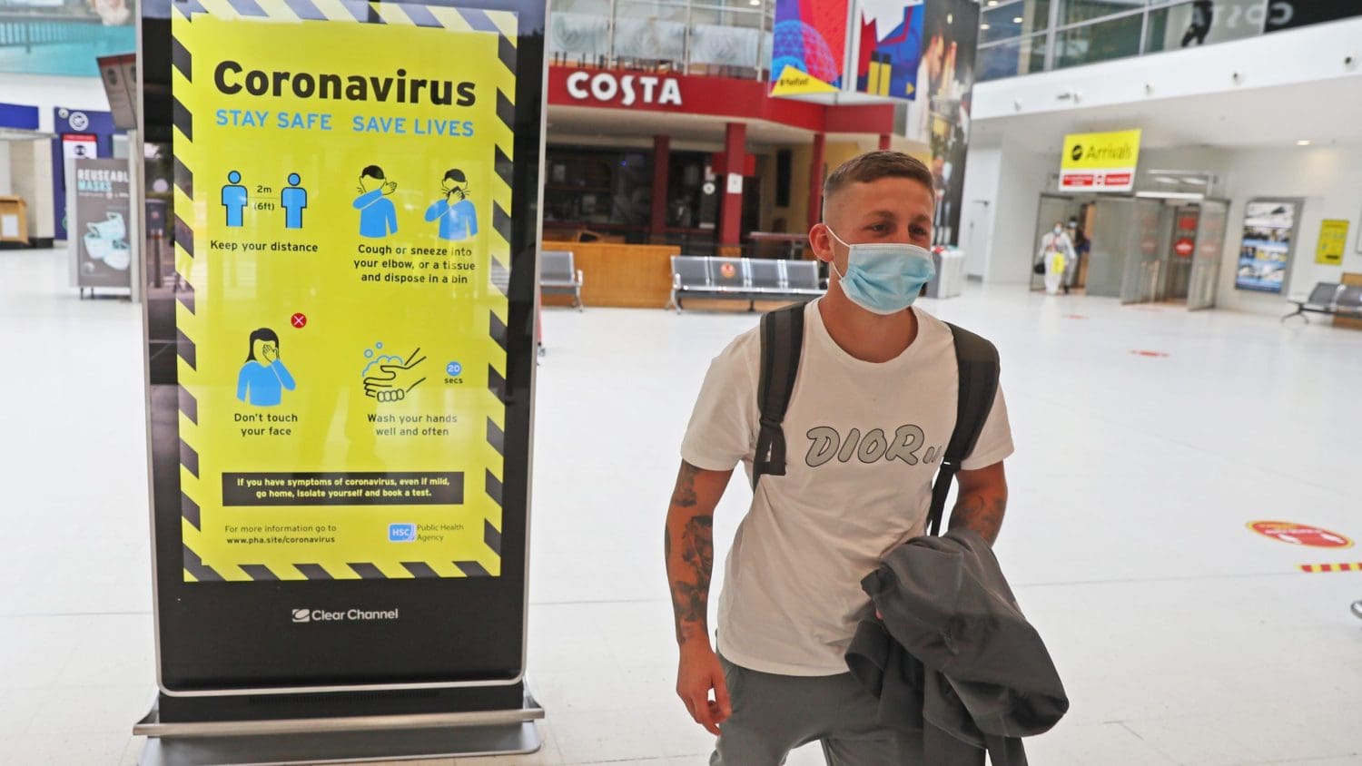 A traveller wearing a mask