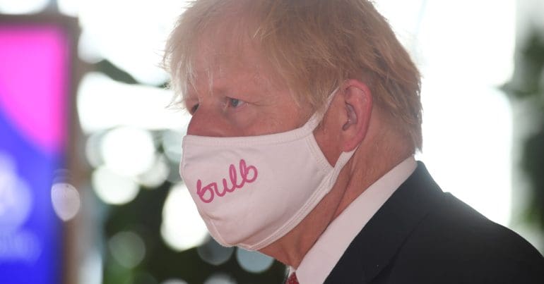 Boris Johnson wearing a face mask with the bulb logo on it