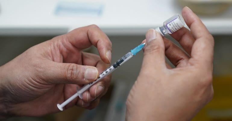 A syringe with a dose of vaccine
