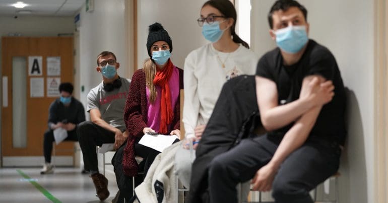 A queue of people waiting to be vaccinated
