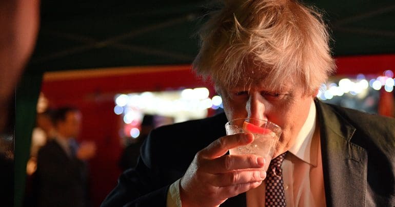 Boris Johnson drinking some sort of cocktail