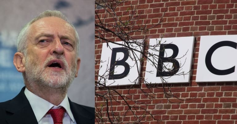 Former Labour Party leader Jeremy Corbyn and a BBC sign on a brick wall