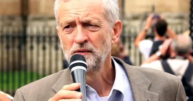 Corbyn speaking into a mic