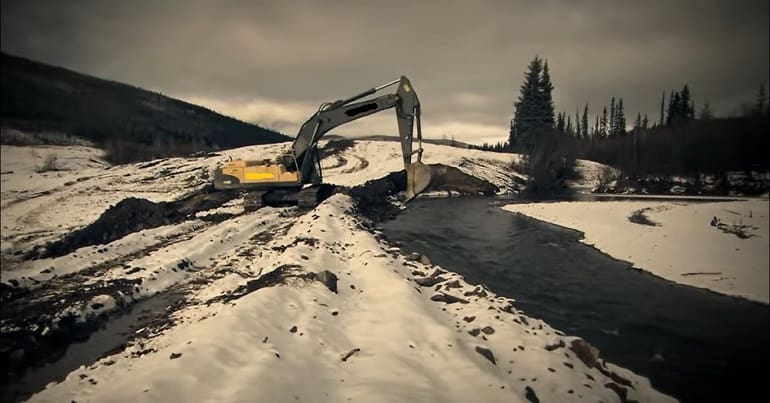 A digger mining at a river in Guyana