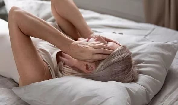 A picture of a woman holding her head