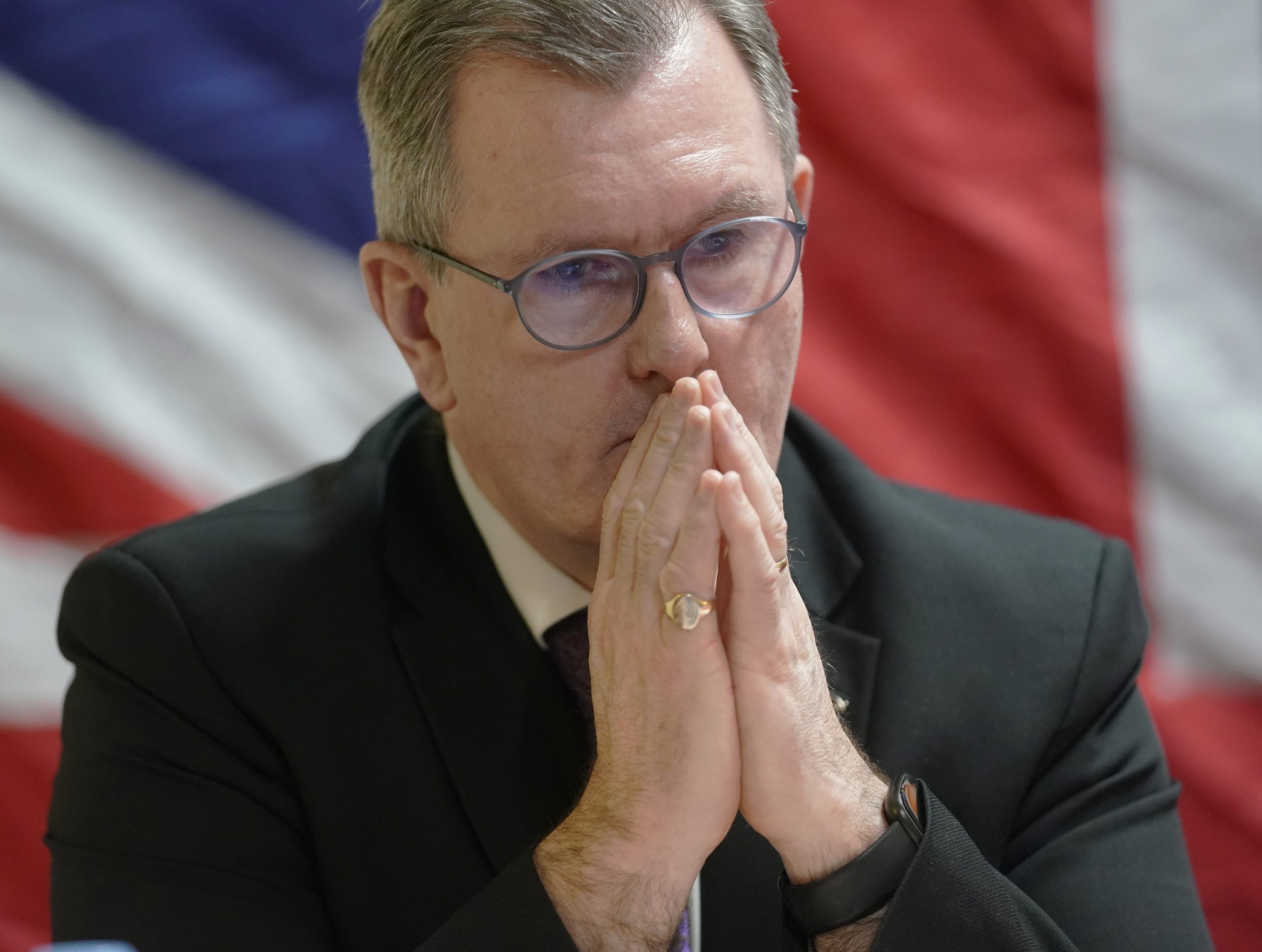 Jeffrey Donaldson pictured in 2022 with his hands in prayer pose to his mouth