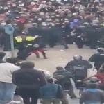 Mariella being kicked to the ground by riot police