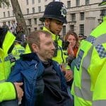 Protestor being detained and carried away by police