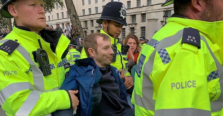 Protestor being detained and carried away by police