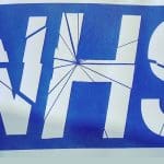 The NHS logo with cracks on it representing the RCN accepting the Tories pay offer