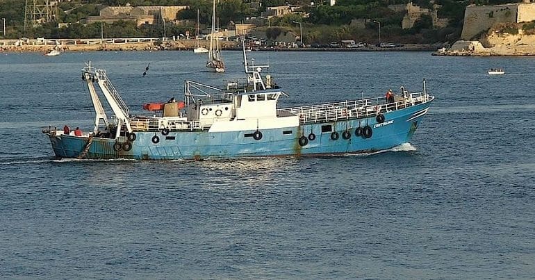 A fishing vessel sailing through waters