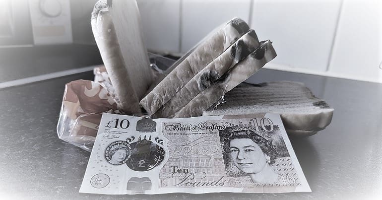 A mouldy loaf of bread and a 10 pound note to represent inflation