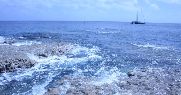 A view of the ocean around Niue, with a boat on the horizon