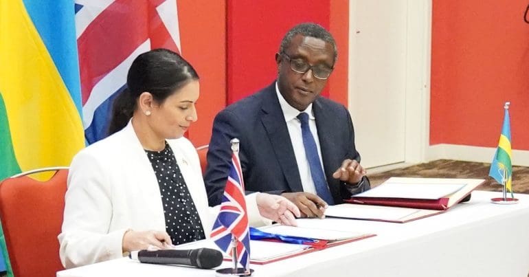 Priti Patel signing papers