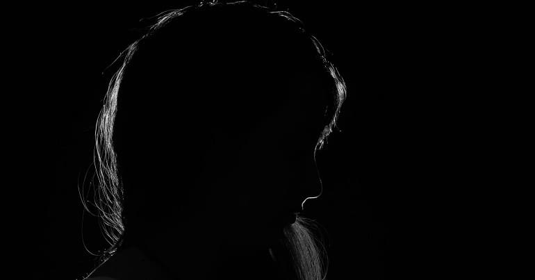A woman in shadow representing chronic illness chronically ill DWP
