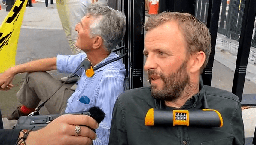 XR members locked to the gates of parliament