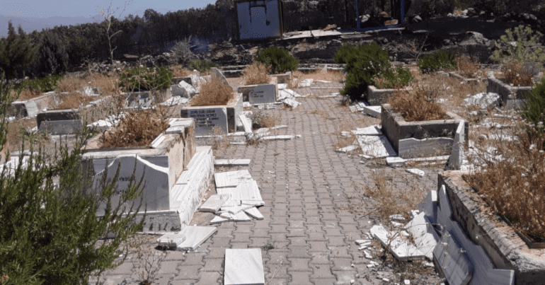Defaced graves in a Kurdish graveyard