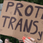 a sign saying "protect trans youth"
