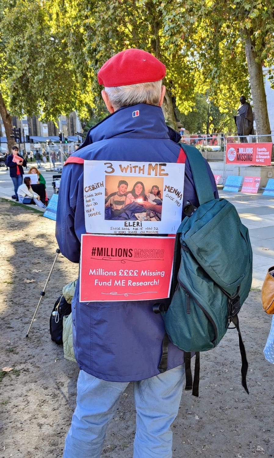 A person with a placard on his back at the Millions Missing protest