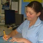 A public sector nurse writing in a hospital