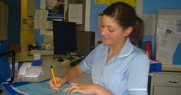 A public sector nurse writing in a hospital