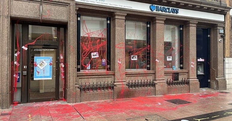 A branch of Barclays bank covered in XR red paint