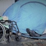 A disabled homeless persons tent and a wheelchair at the Peoples Assembly demo