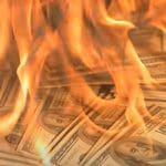 Burning money representing bosses pay