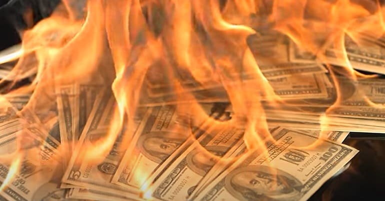 Burning money representing bosses pay