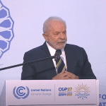 Luiz Inacio Lula da Silva stands at a Global Climate Action podium