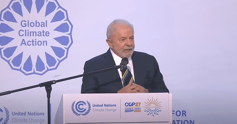 Luiz Inacio Lula da Silva stands at a Global Climate Action podium