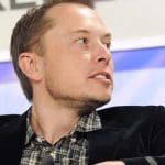 Elon Musk, Twitter owner, turns to his left.