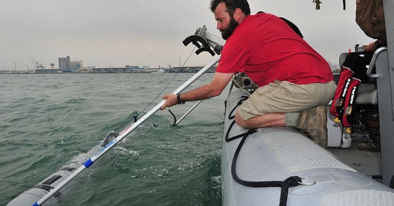 A US underwater drone is lowered into the sea.