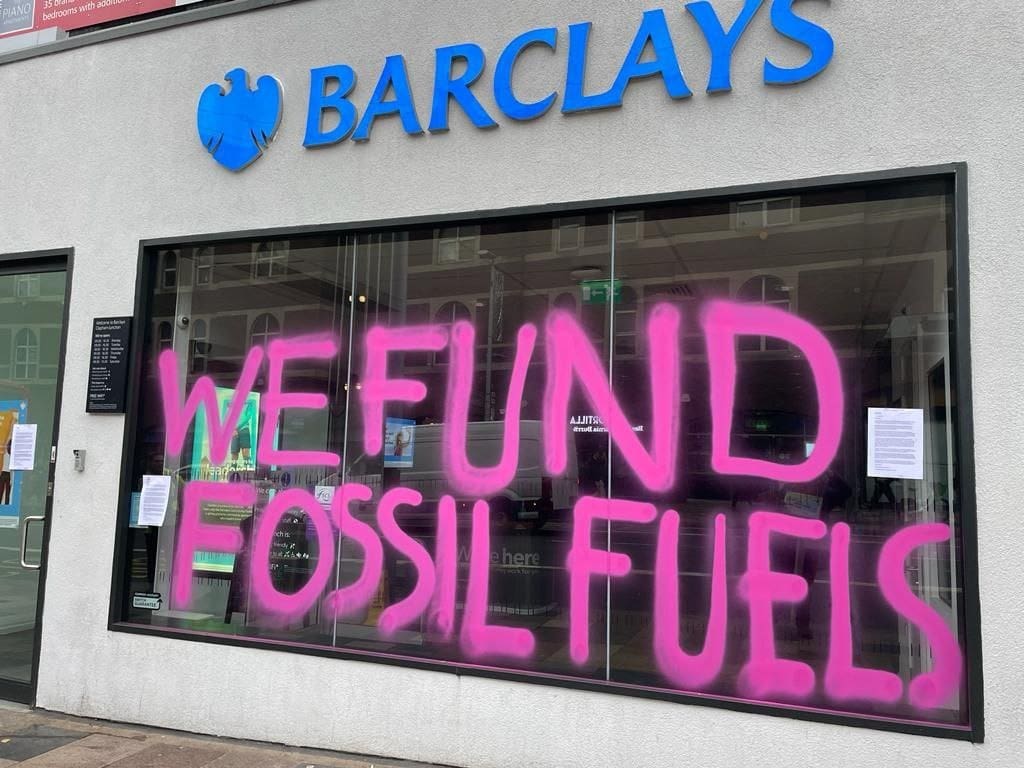 Barclays spray painted with the slogan "we fund fossil fuels"