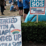 protest sign reads "started with a clap, ended with a slap" representing the RCN and nurses NHS strike