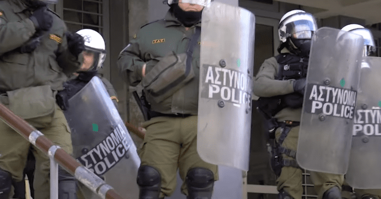 Greek police hold riot shields up