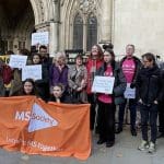 People at a vigil during a DWP court case