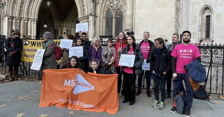 People at a vigil during a DWP court case